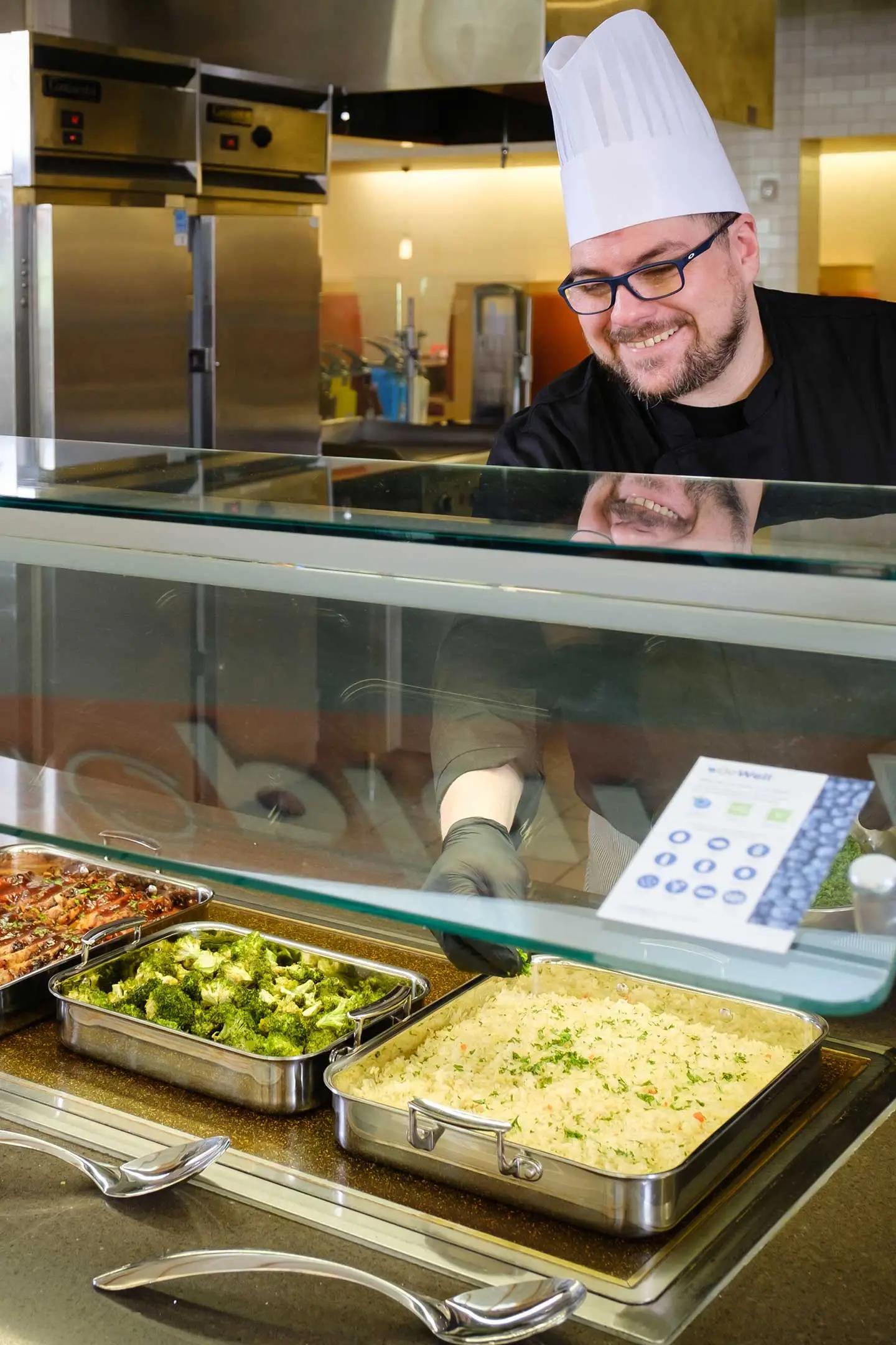 Chef smiling behind serving line